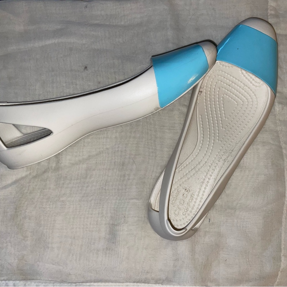 White and aqua Crocs flats